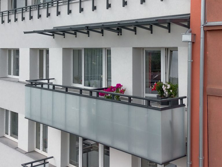 Balkon se stříškou a s Al zábradlím s výplní z bezpečnostního mléčného skla
